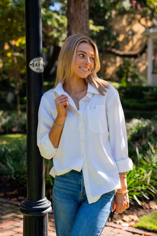 Elody white organic cotton button-down shirt styled with blue jeans, showing its relaxed oversized fit