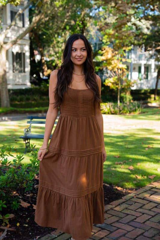 Woman wearing the Elody brown organic cotton Maxi Dress with a tiered full-length silhouette
